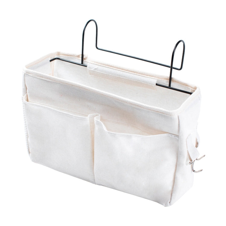 White hanging bedside storage bag with multiple compartments and front divider pouch