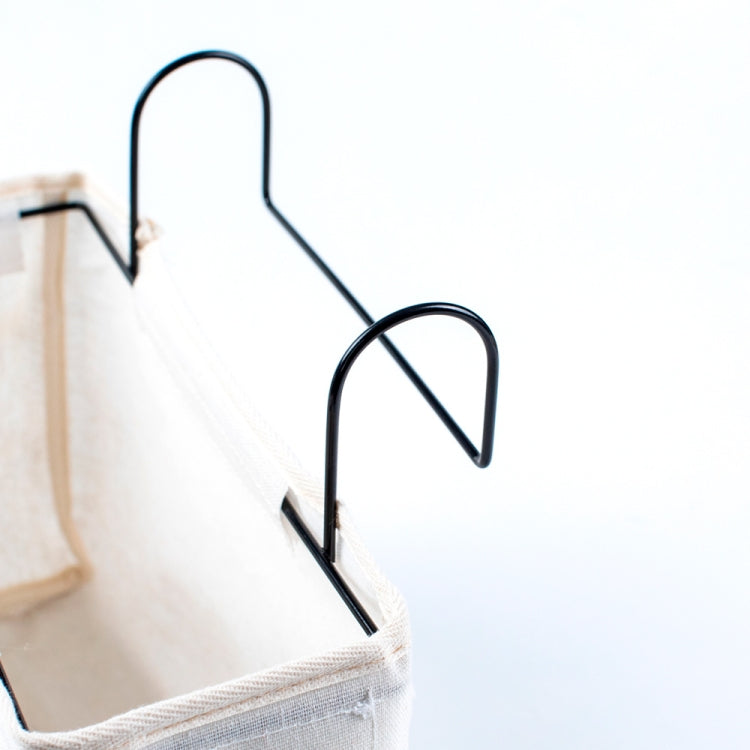 Hanging storage bag with black metal hooks for bedside attachment
