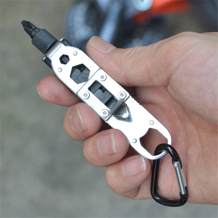 Hand holding mini screwdriver tool with metal bit set and black textured handle