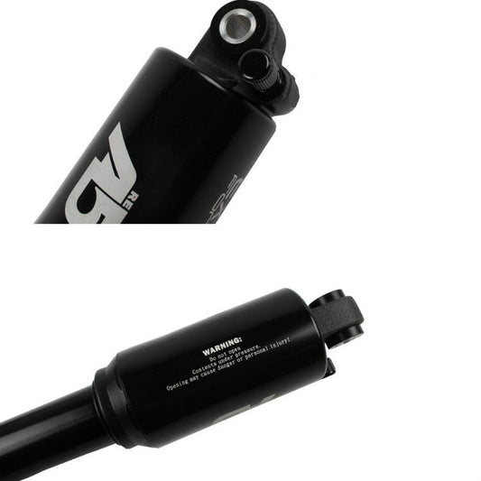 KindShock air shock absorber, black body with adjustment knob and warning label