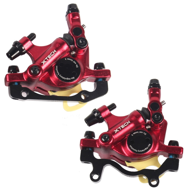 Pair of red hydraulic disc brake calipers with mounting brackets and hose ports