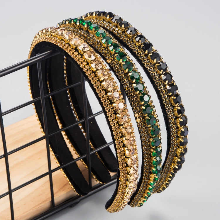 Rhinestone headband with gold edging, green and black stone rows, black base