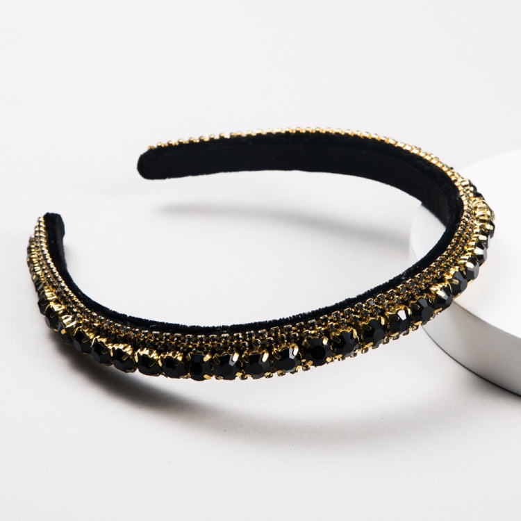 Black velvet headband with gold sparkle border and green/black rhinestones