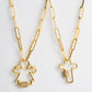 Gold-tone cross pendant necklace set with zircon-stone accents and link chain