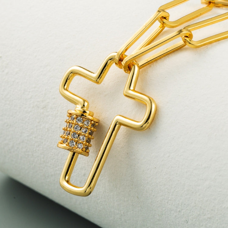 Gold-tone cross pendant necklace close-up with zircon stone column and link chain