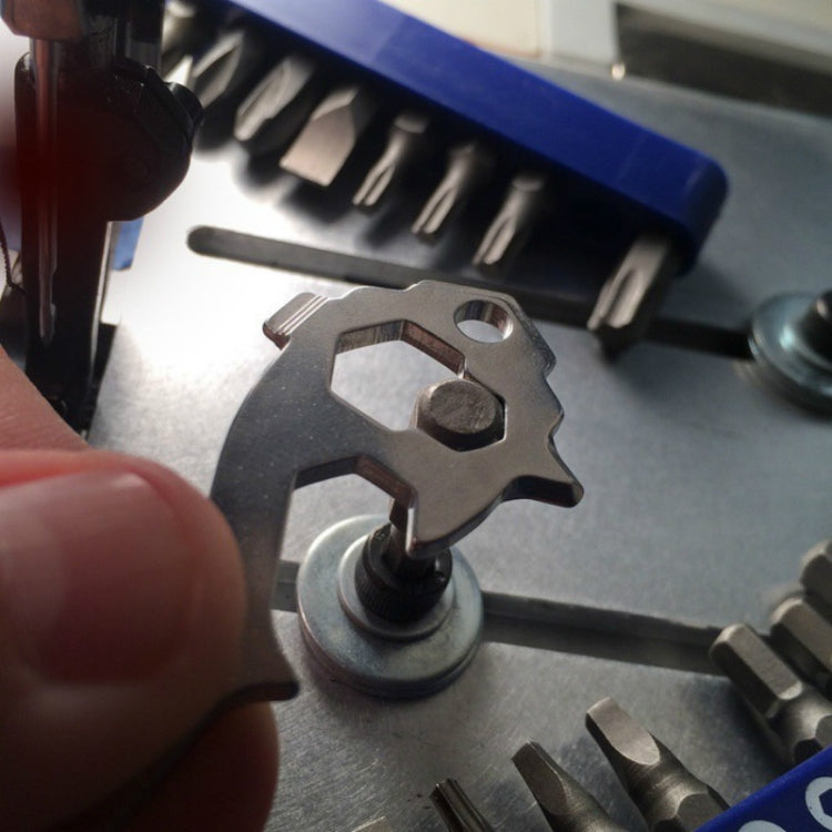 Key ring multi-tool bit being used on a vehicle engine panel