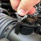 Key ring multi-tool engaged on a vehicle headlight assembly fastener