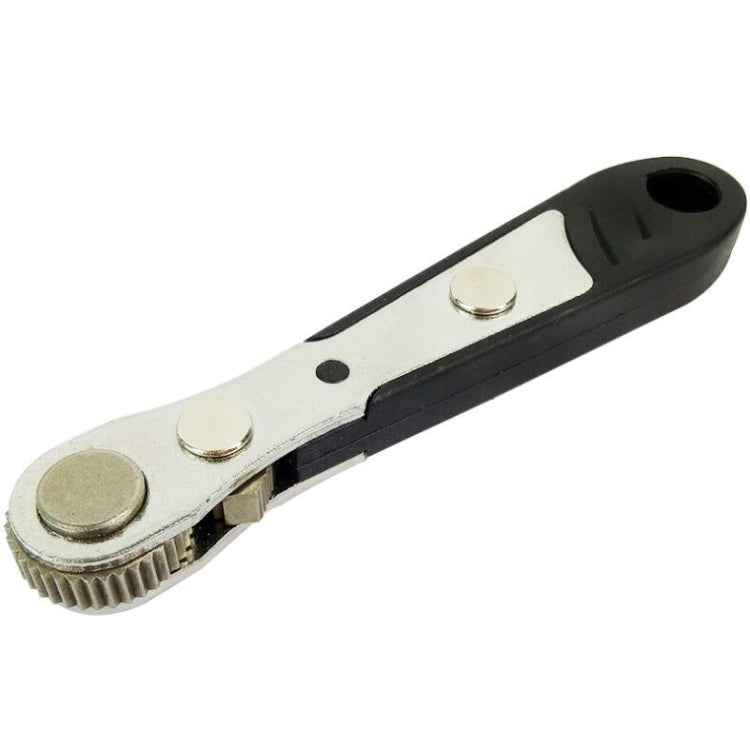 Mini ratchet wrench with black handle, silver face, and visible gear mechanism