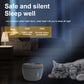 White and gray electric pet water dispenser with blue glow beside sleeping gray cat