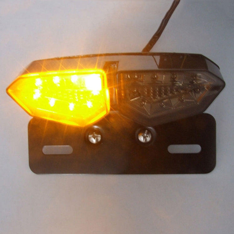Motorcycle LED tail light with amber left light glowing and smoked lens housing