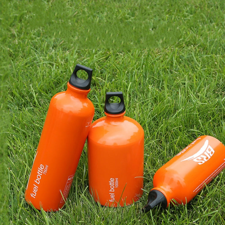 Orange outdoor fuel bottle pair in grass, black caps with carry loops.