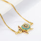 Gold-tone chain bracelet with turtle charm, blue center and black with pink stone accents