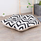 Pet sleeping mat bed with black-and-white zigzag patterned cover and beige bottom edge