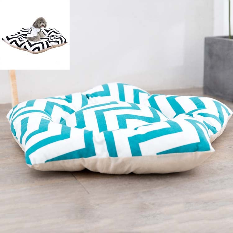Small dog sleeping mat bed with white-and-teal geometric pattern top and cream base
