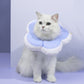 Pet anti-licking flower collar with light blue plush petals and white ruffled edge, worn by cat