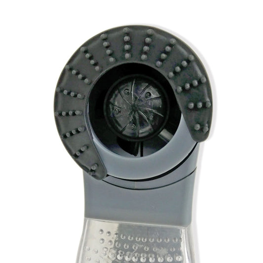 Close-up of round suction brush head with spiked nubs and central suction opening