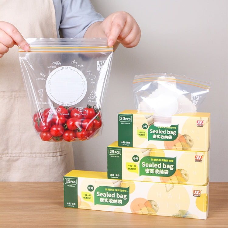 Clear sealed food storage bags with orange stripe tops, one bag holding cherry tomatoes