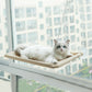 Cat resting on window-mounted suction cup cat hammock with tan fabric platform