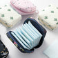 Open square zip pouch sanitary napkin storage with folded light-blue pads inside
