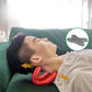 Red neck pillow massager under the head on a bed for cervical support