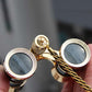 Gold-rim opera binoculars with focus wheels and braided carrying chain
