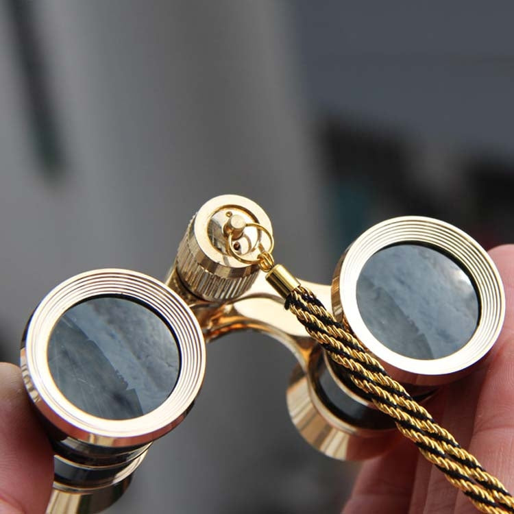 Gold-rim opera binoculars with focus wheels and braided carrying chain