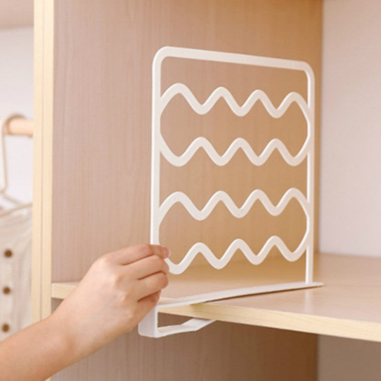 White wave shelf divider bar attached to shelf edge, hand positioning it