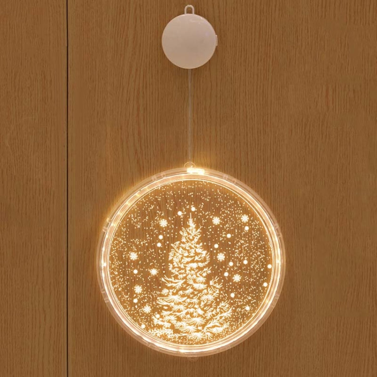 Hanging LED light decoration with glowing Christmas tree in sparkling snowfall