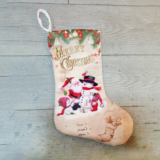Beige fabric Christmas stocking with 'Merry Christmas' and snowman illustration.
