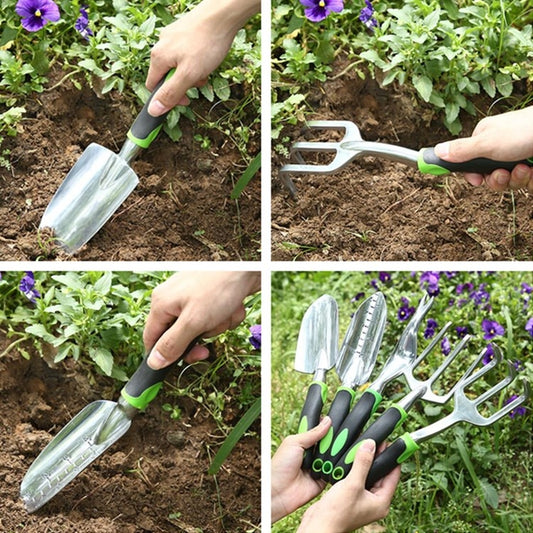 Garden hand tool set with shovel and fork heads in use among plants