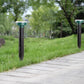 Solar mouse repeller stakes in green-capped form on outdoor lawn with rain