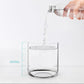 Clear humidifier water tank cup being filled with water, with volume markings