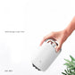 White portable humidifier with black top, hand holding the device