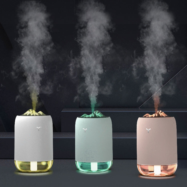 Car humidifiers in pink, turquoise, and white emitting mist from the top nozzles