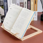 Wooden reading rack supporting an open book with metal clips, light wood frame