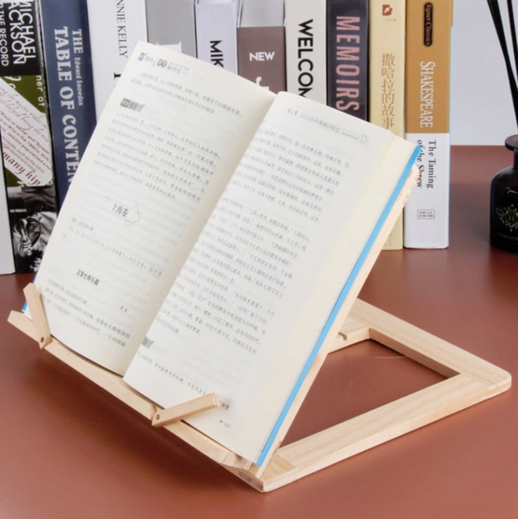 Wooden reading rack supporting an open book with metal clips, light wood frame