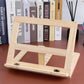 Wooden book stand display rack with front metal clips and open center, natural light wood