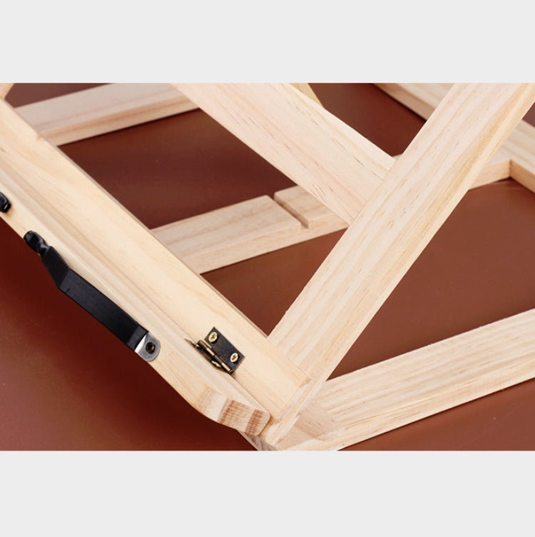 Wooden book stand close-up of black metal clip and wood slats, light natural wood
