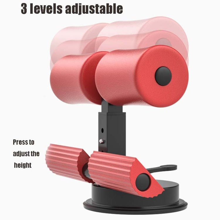 Red and black adjustable suction-cup abdominal curler sit-up aid with foam rollers.