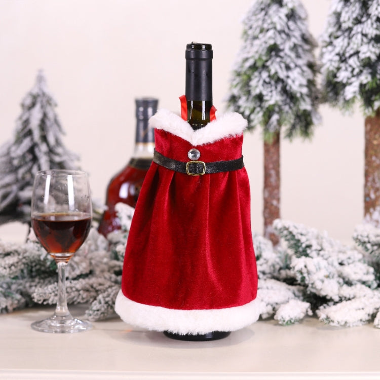 Red velvet wine bottle decoration dress with white trim and black belt, on a bottle.