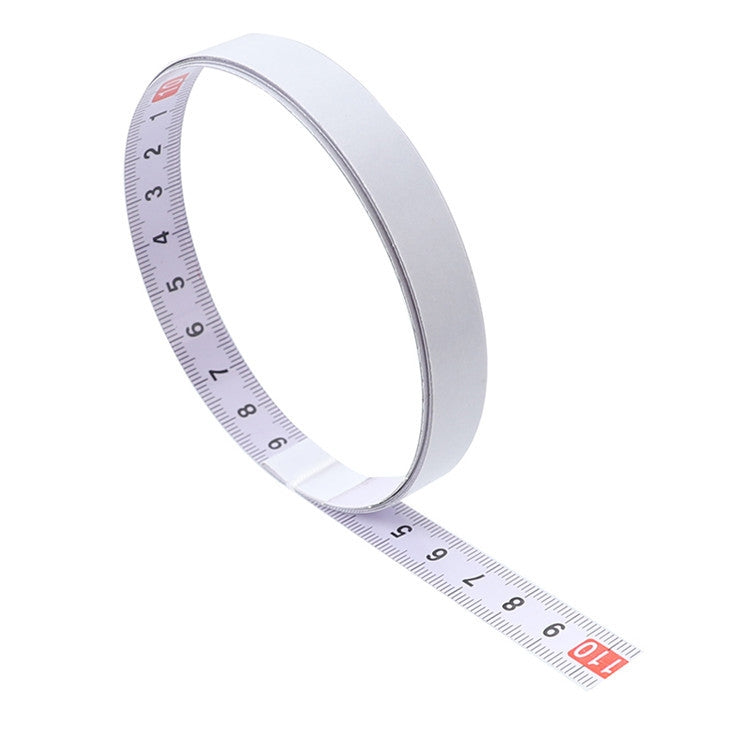 Self-adhesive steel tape measure in curve with metric scale markings on strip