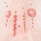 Set of red and white candy swirl Christmas ornaments on pale fabric