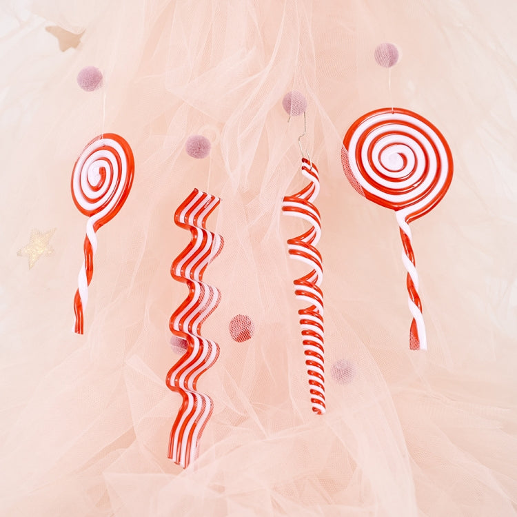 Set of red and white candy swirl Christmas ornaments on pale fabric