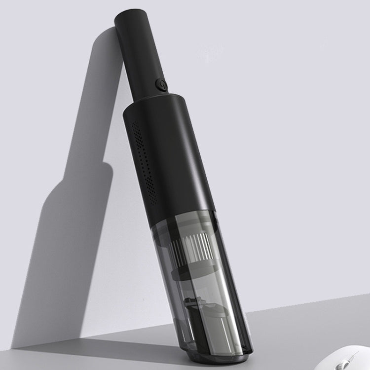 Black handheld vacuum cleaner standing upright with transparent dust chamber
