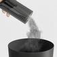 Handheld vacuum cleaner with nozzle releasing dust from transparent collection chamber