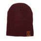 Dark red knit baby beanie with folded cuff and square leather patch label