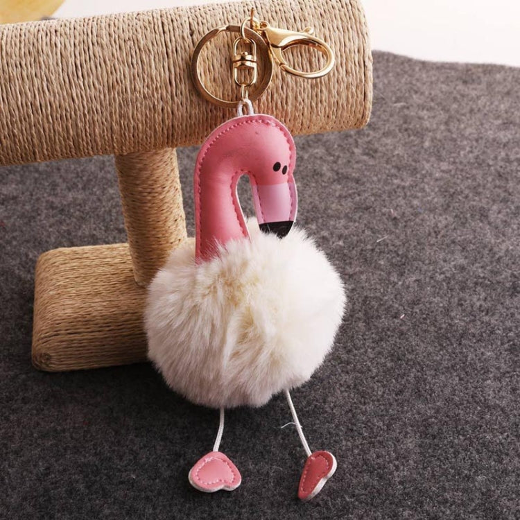 Flamingo plush keychain with white pom pom body, pink beak, two dangling feet