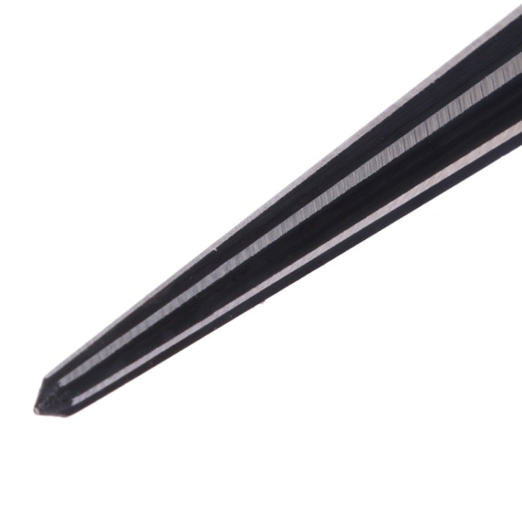 Close-up of taper reamer pointed tip showing black grooves and metal surface