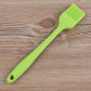 Lime green silicone oil basting brush with fan bristle head and hanging hole handle.