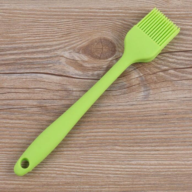 Lime green silicone oil basting brush with fan bristle head and hanging hole handle.